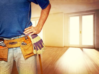 Worker in blue shirt with tools in a room
